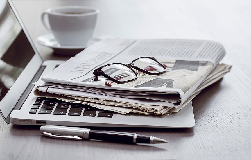 Newspaper and laptop